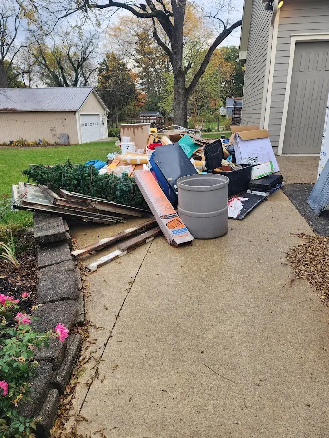 Dumpster being loaded with debris for Estate Cleanout Dumpster Rental in Shakopee